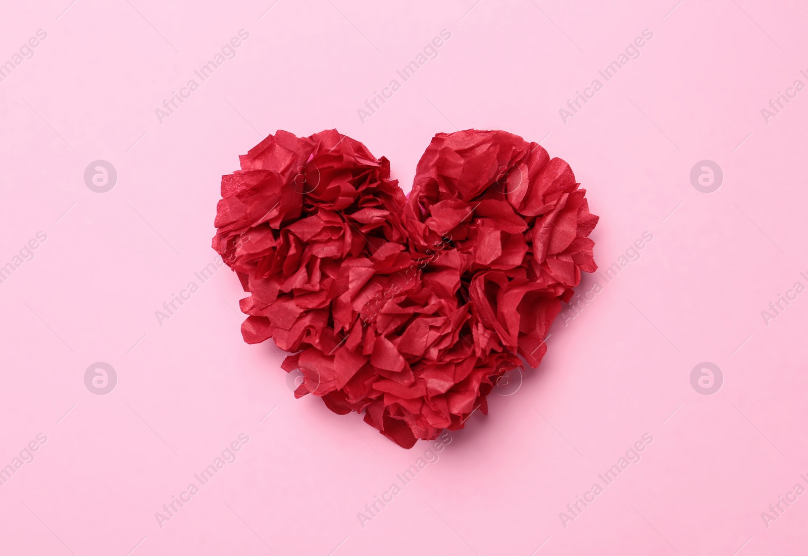 Photo of Red heart on pink background, top view