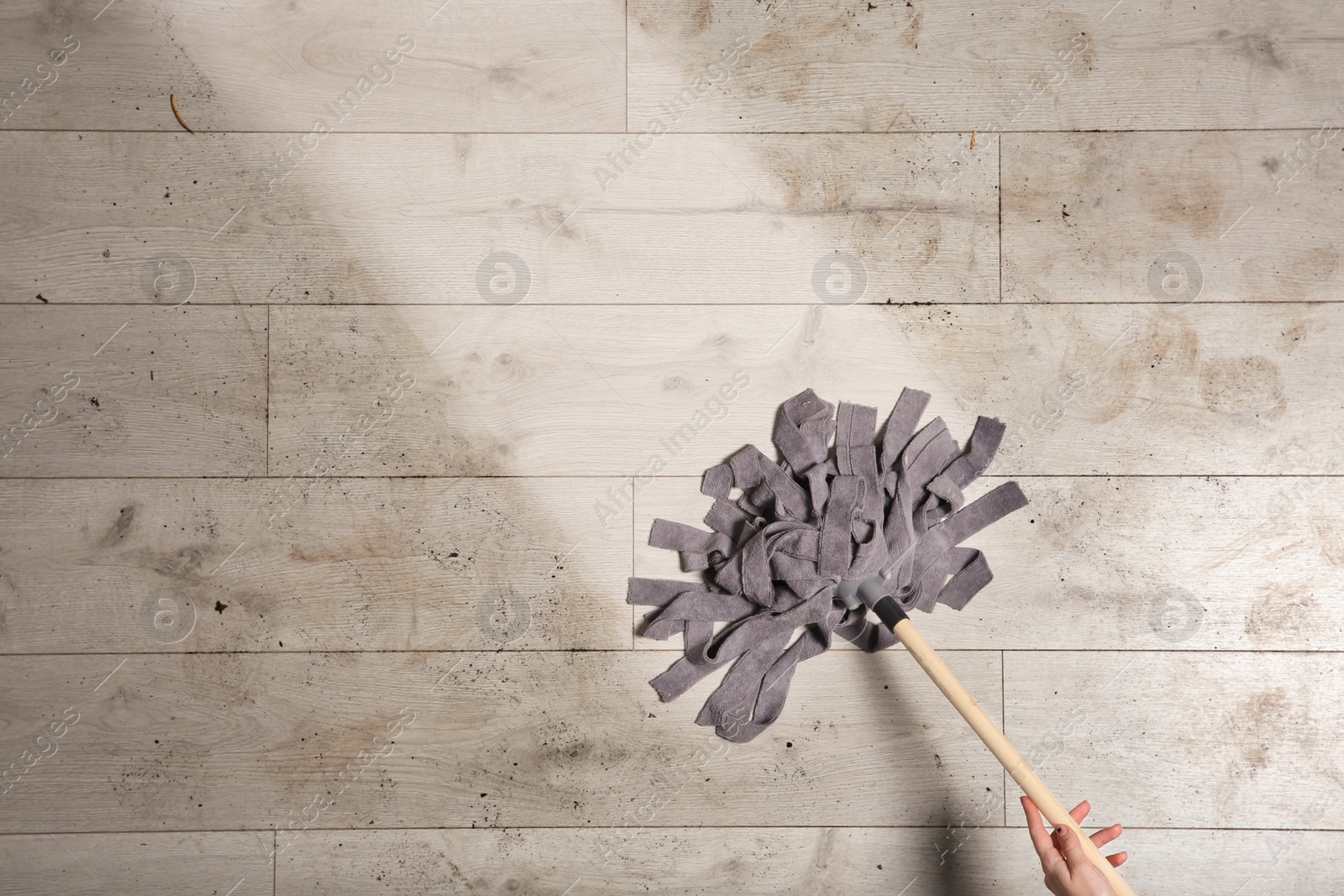 Photo of Professional cleaner washing dirty floor with mop, top view. Space for text