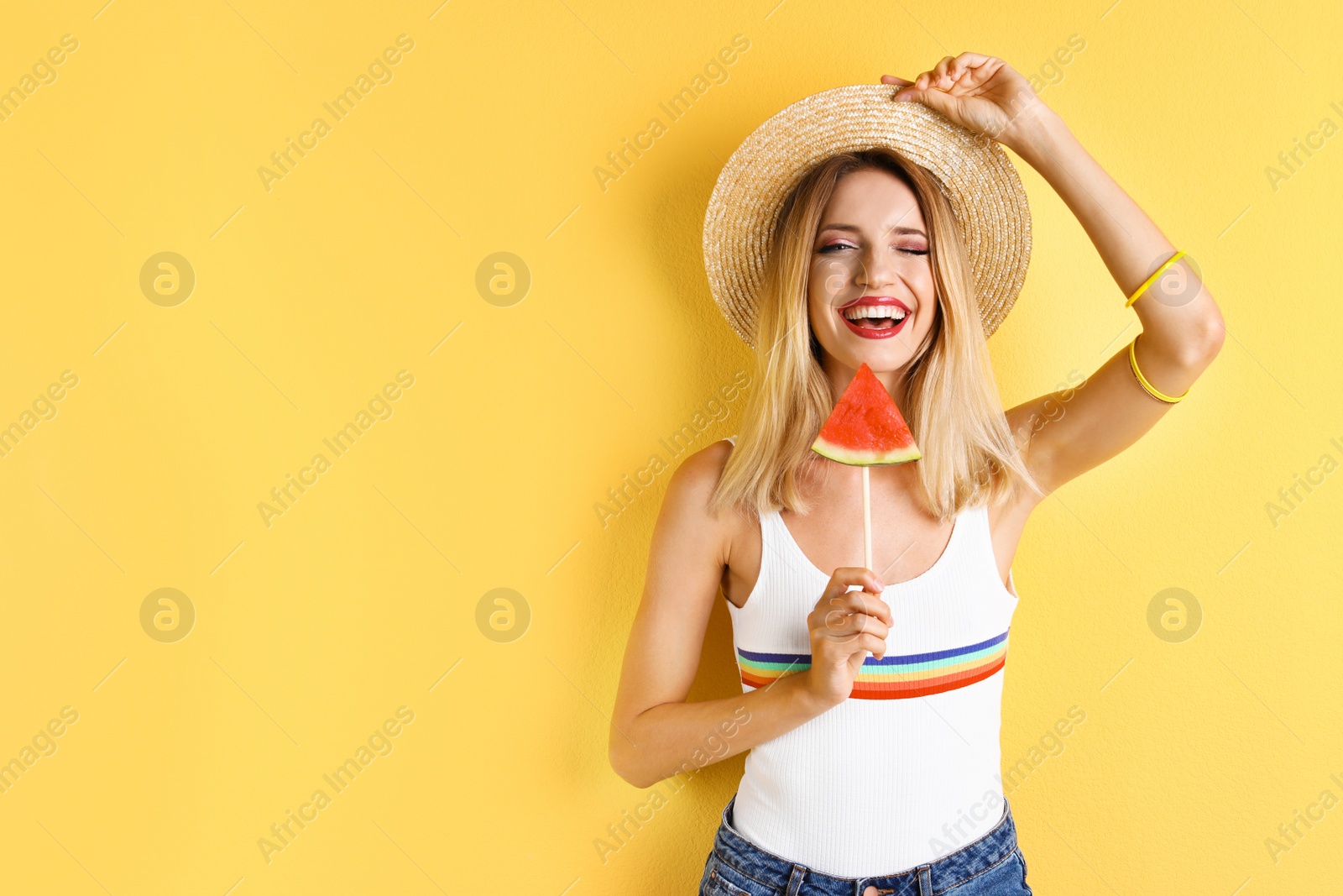 Photo of Pretty young woman with juicy watermelon on color background