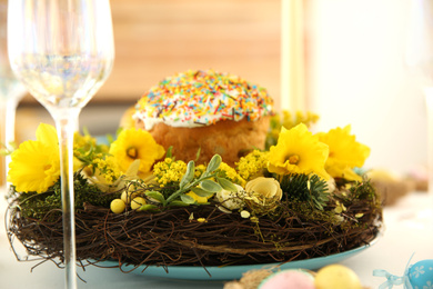 Photo of Festive Easter table setting with beautiful wreath indoors