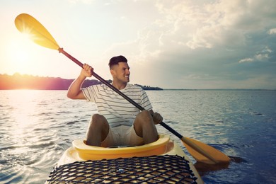 Happy man kayaking on river. Summer activity
