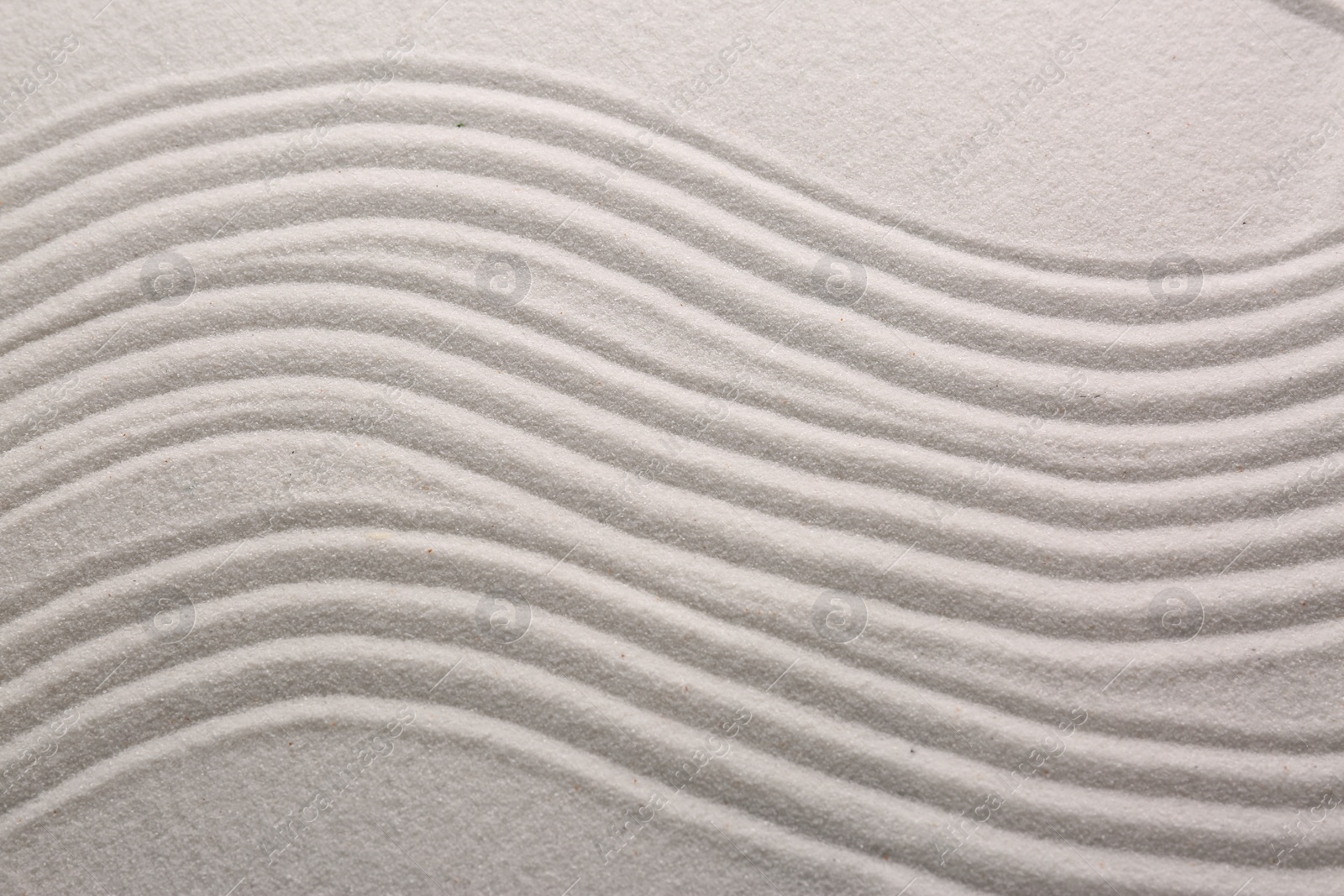 Photo of White sand with pattern as background, top view. Concept of zen and harmony