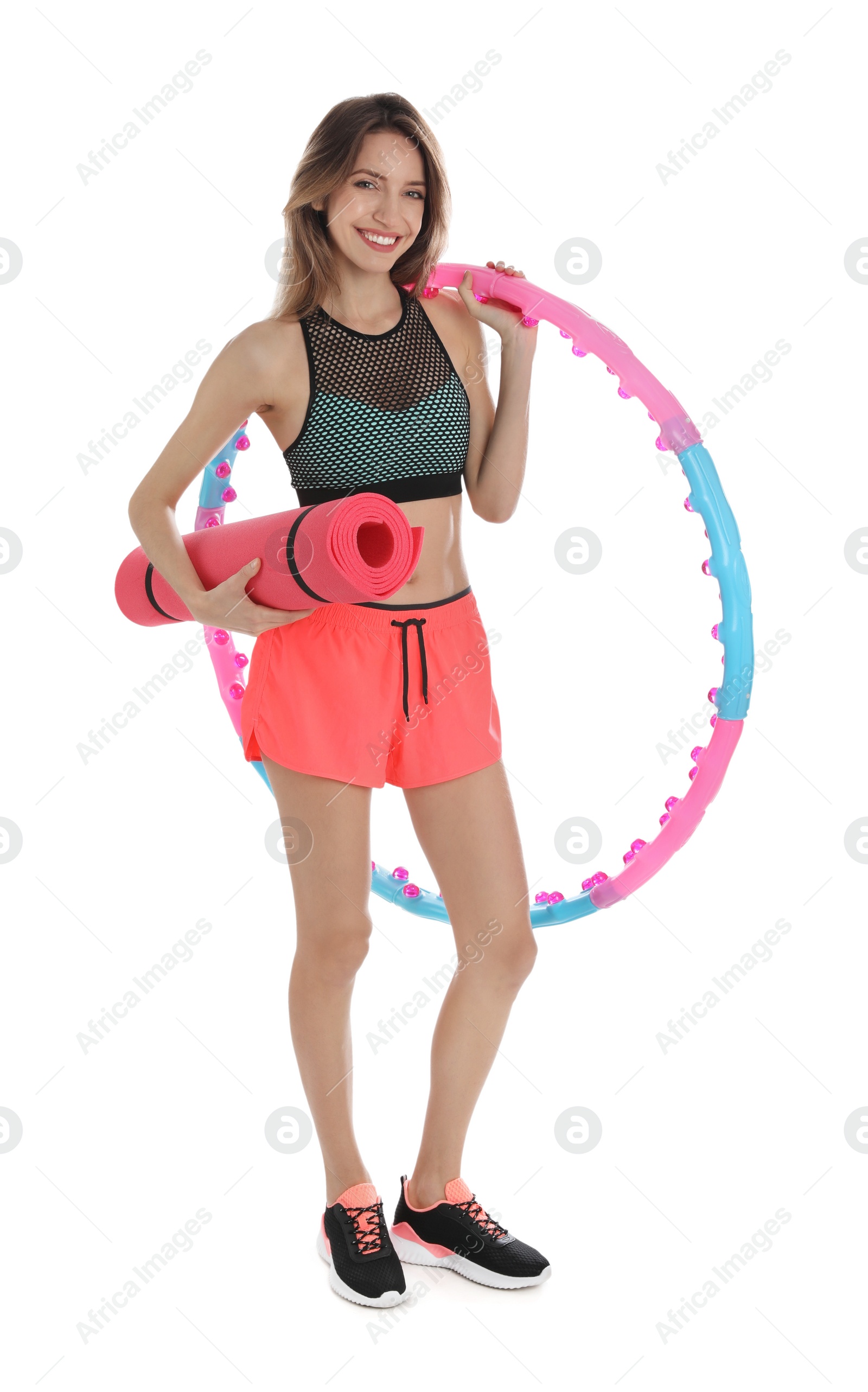 Photo of Beautiful woman with yoga mat and hula hoop on white background