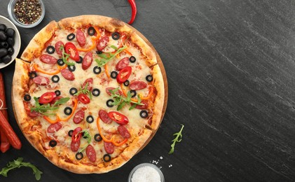 Tasty pizza and ingredients on grey table, top view. Space for text