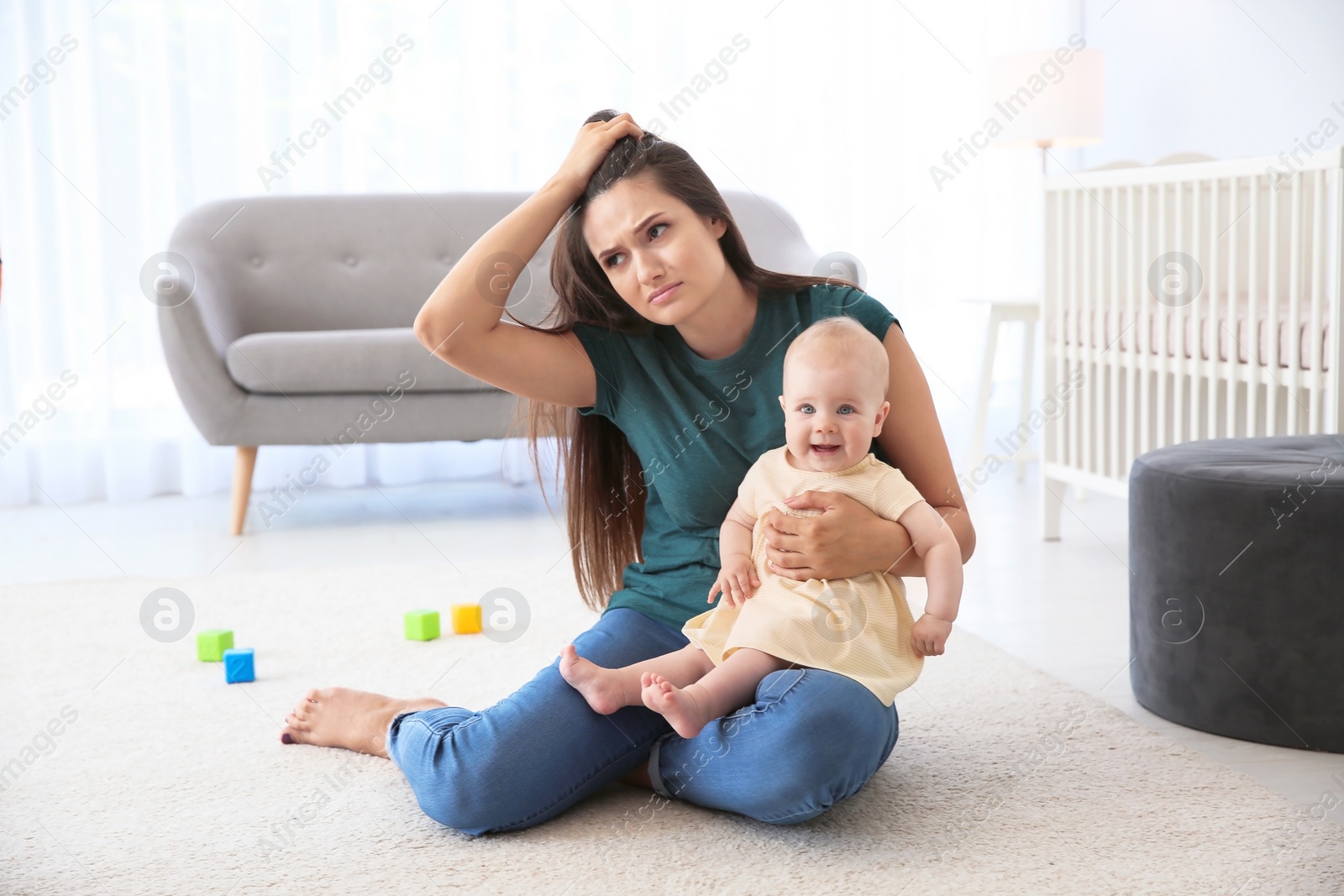 Photo of Young mother suffering from postnatal depression and cute baby girl at home