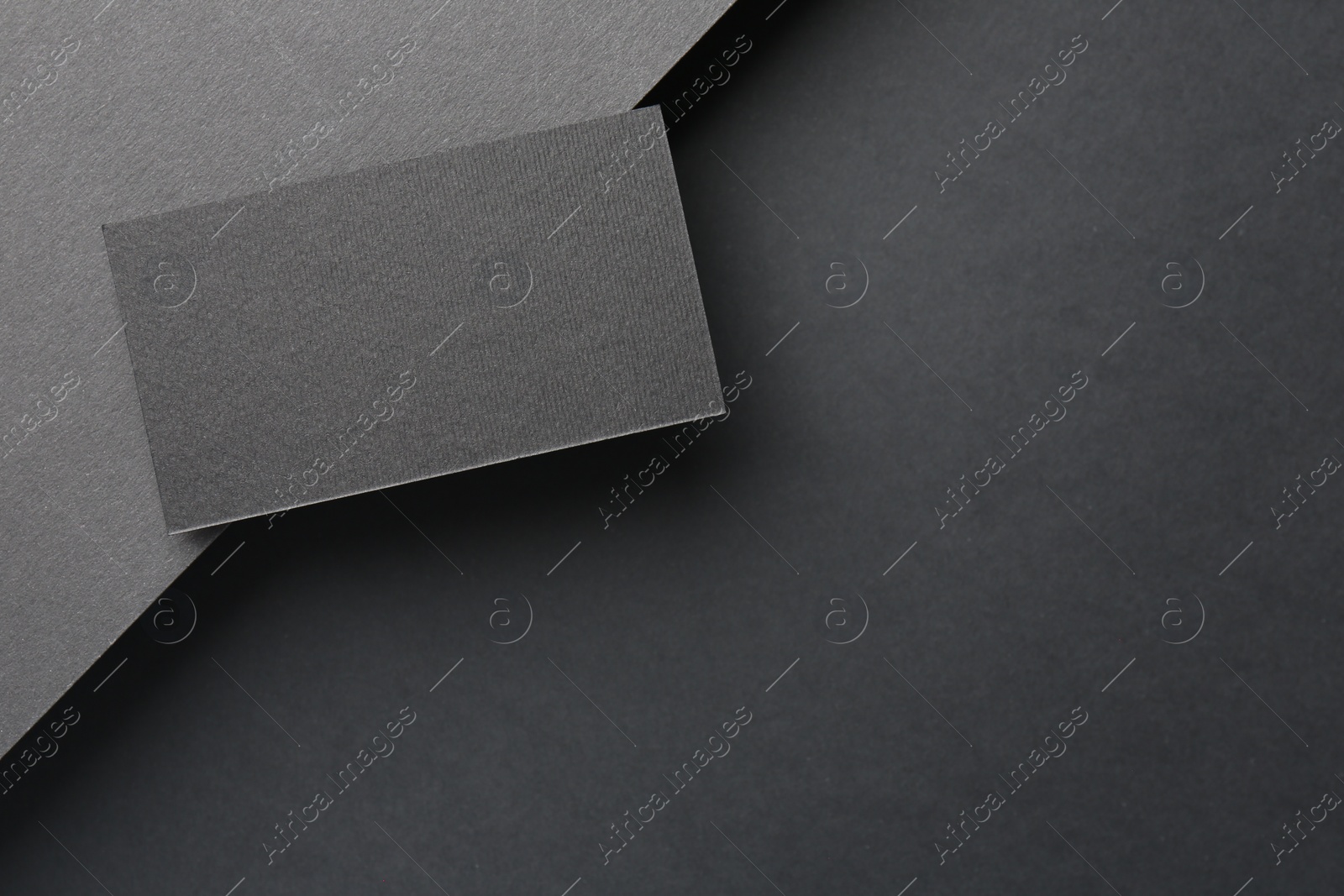 Photo of Blank business card on black background, top view. Mockup for design