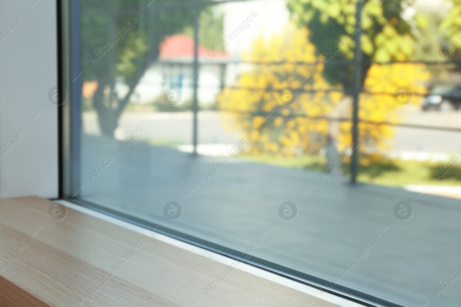 Photo of Closeup view of window with empty wooden sill