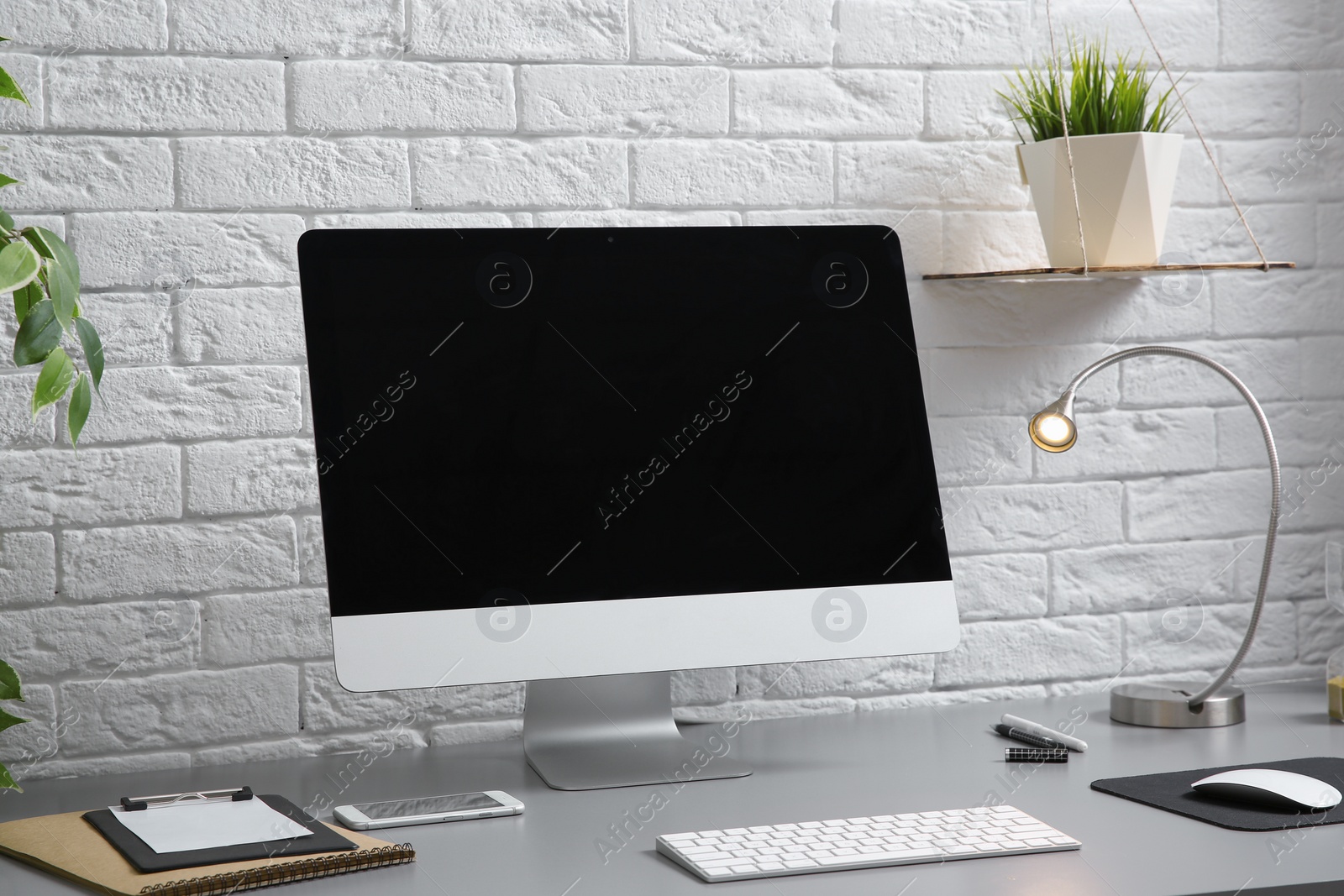 Photo of Interior of comfortable work place with computer on table at home