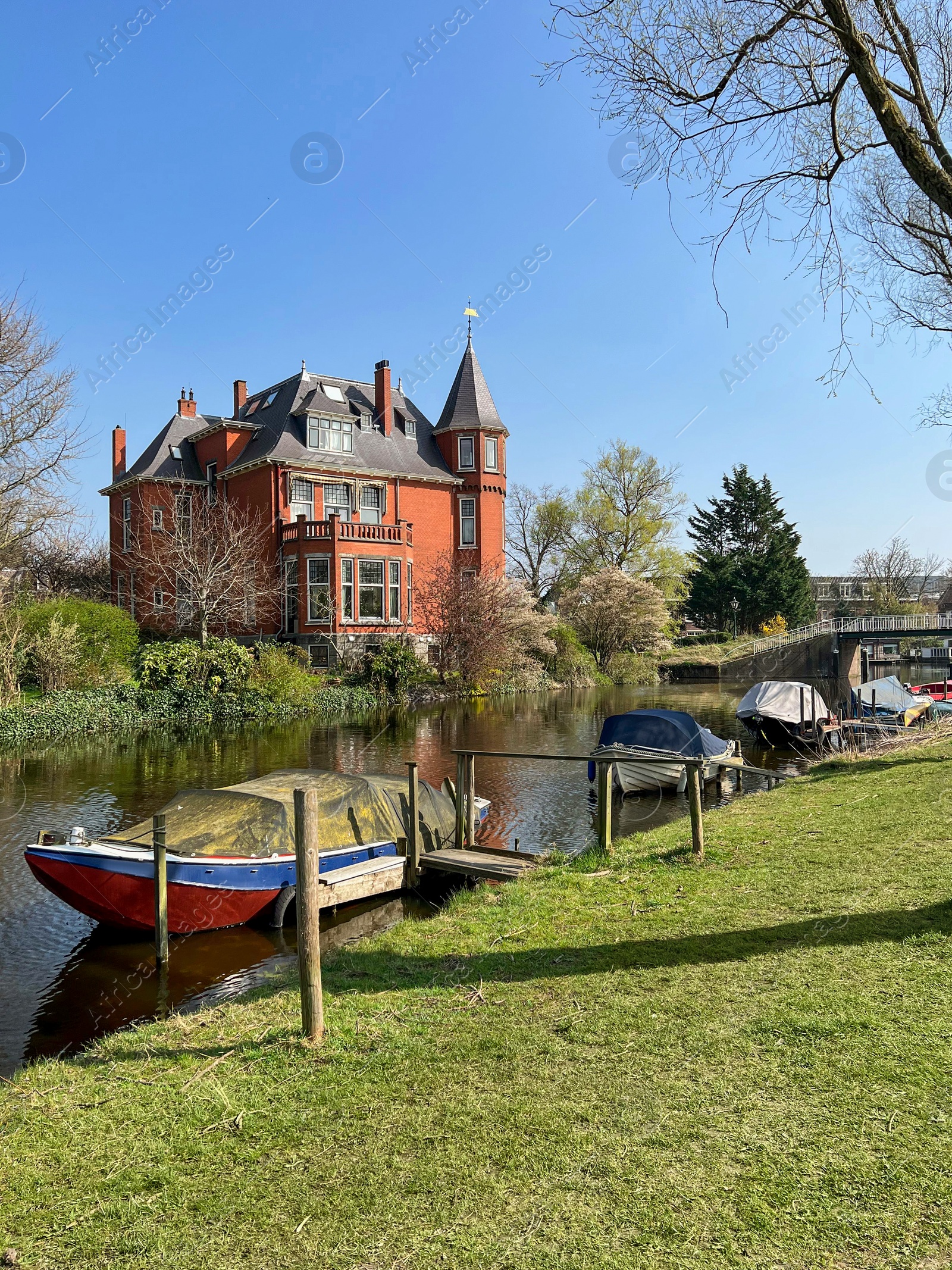 Photo of Beautiful city canal with moored boats on sunny spring day