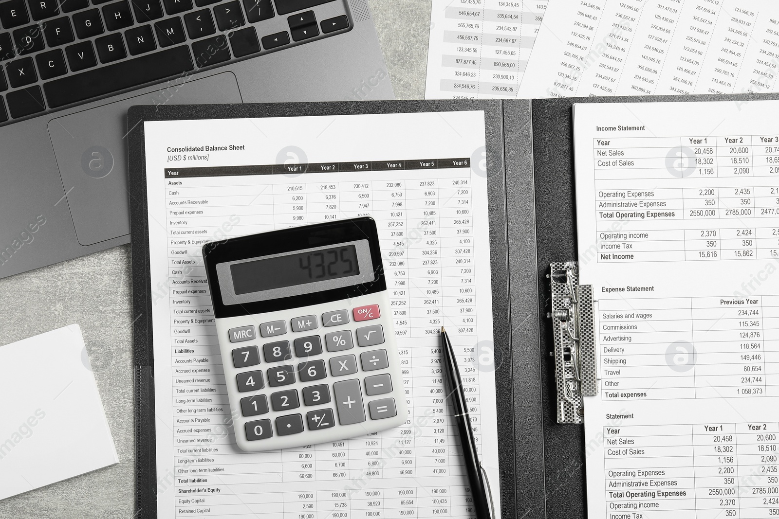 Photo of Calculator, laptop and financial documents on grey table, flat lay