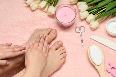 Photo of Closeup of woman with neat toenails after pedicure procedure on pink terry towel, top view