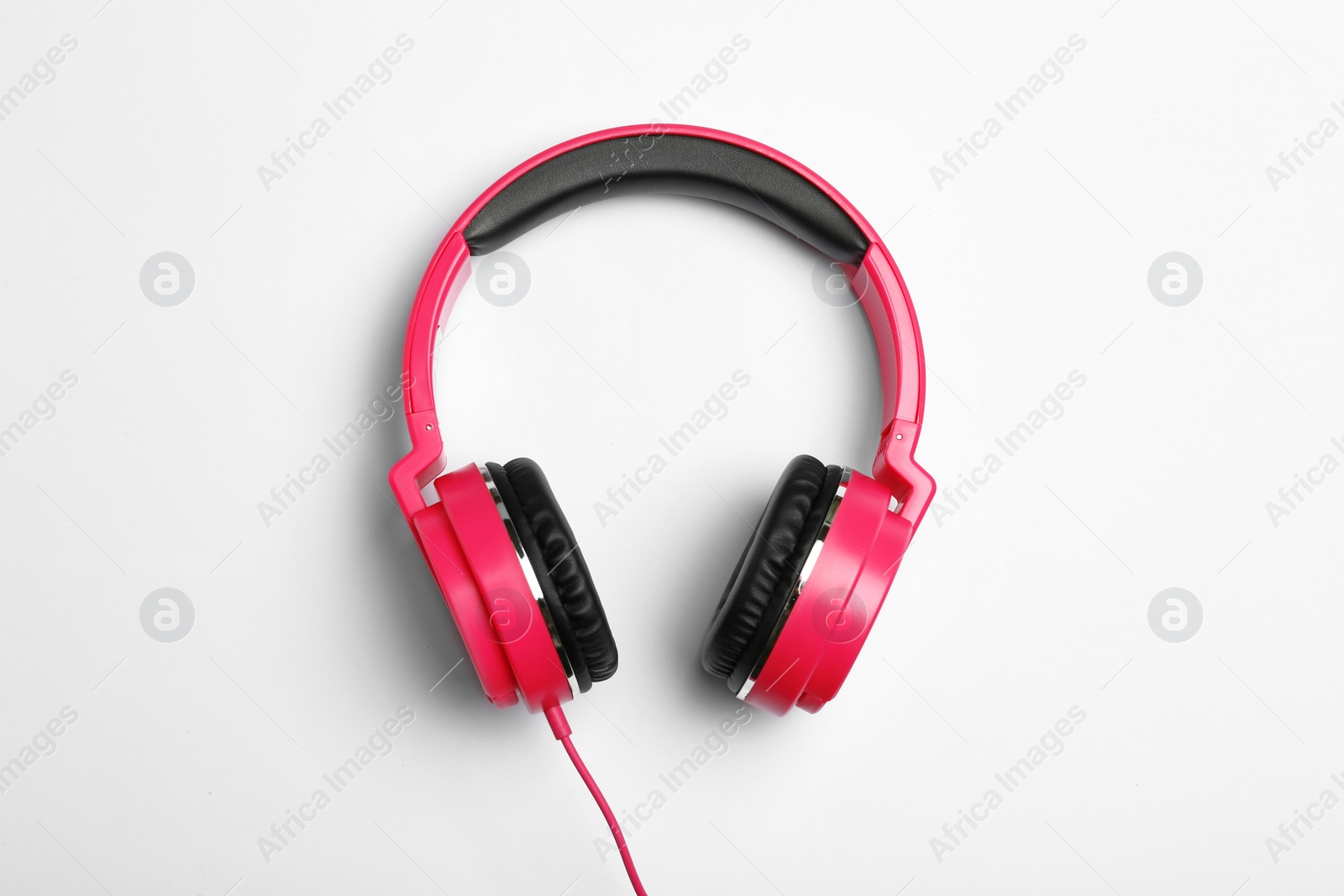 Photo of Stylish modern headphones on white background, top view