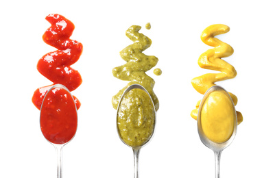 Image of Set of spoons with different delicious sauces on white background, top view