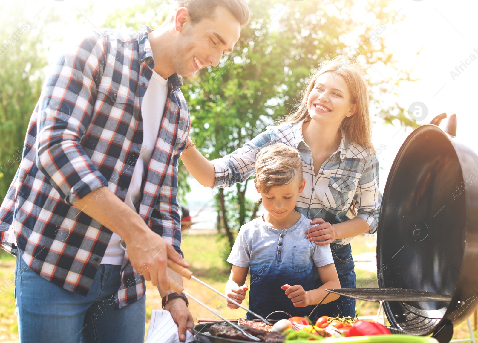 Image of Happy family having barbecue with modern grill outdoors on sunny day