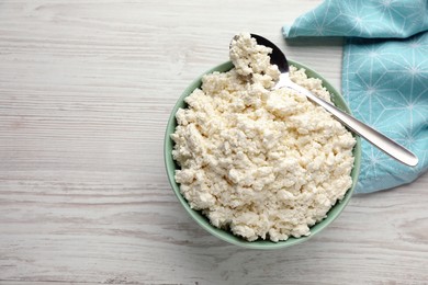 Delicious fresh cottage cheese on white wooden table, flat lay. Space for text