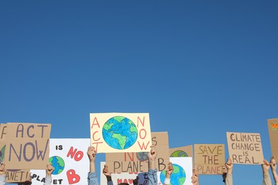 Photo of Group of people with posters protesting against climate change outdoors, closeup