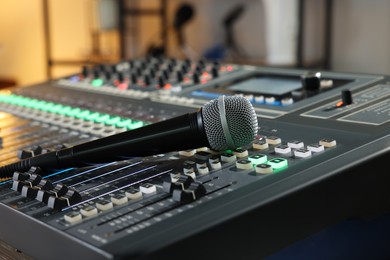 Microphone on professional mixing console in radio studio
