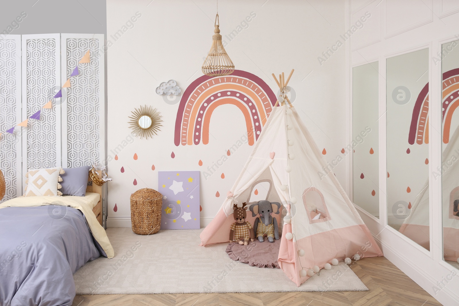 Photo of Stylish room with comfortable bed and teepee tent for kids. Interior design