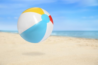 Image of Colorful inflatable beach ball and seascape on background