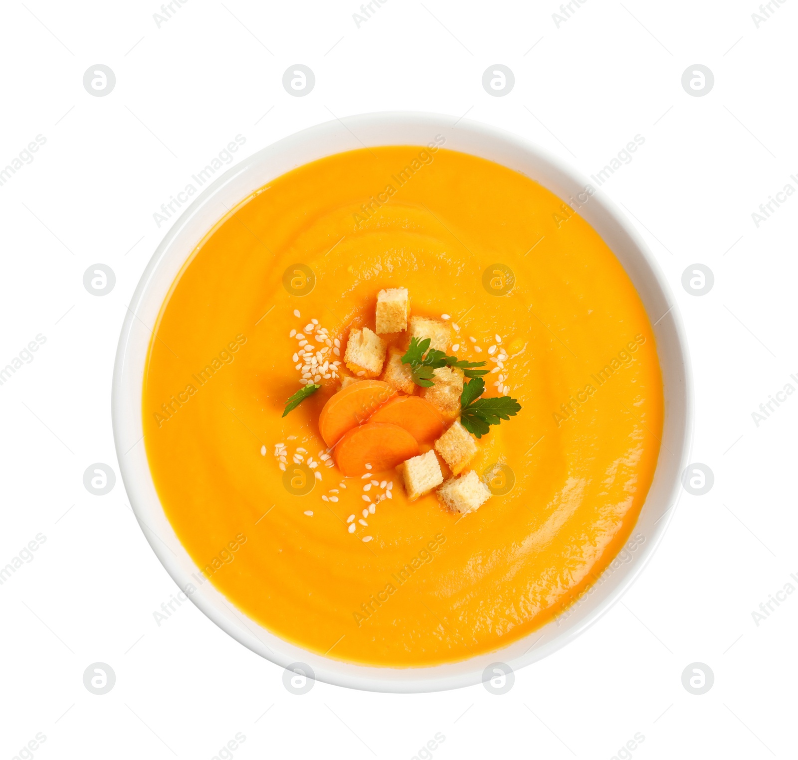 Photo of Dish with carrot cream soup on white background, top view. Healthy food