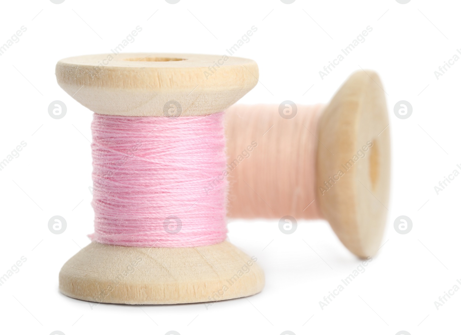 Photo of Different colorful sewing threads on white background, closeup