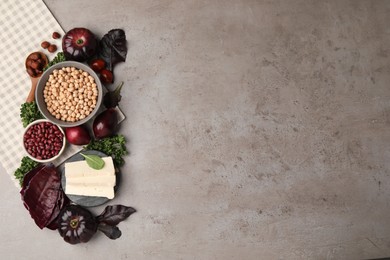 Photo of Tofu cheese and different vegetables on grey table, flat lay with space for text. Vegan diet