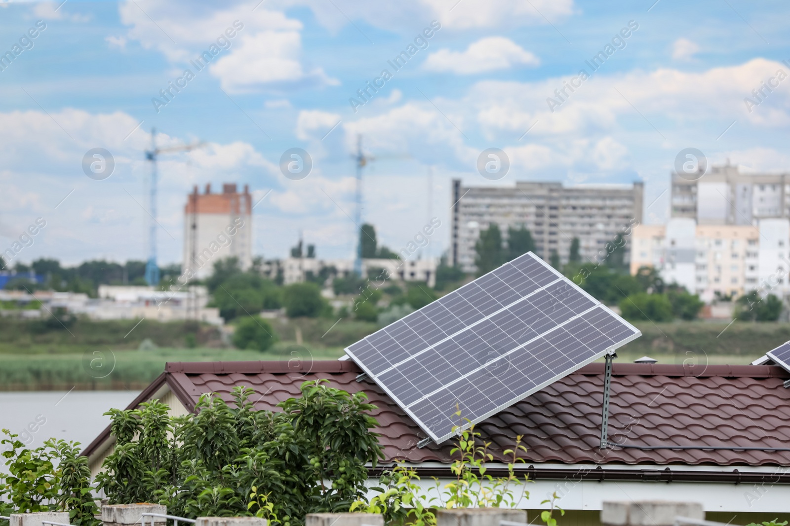 Photo of House with installed solar panels on roof. Alternative energy source