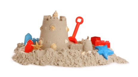 Photo of Plastic beach toys and figure on pile of sand against white background. Outdoor play