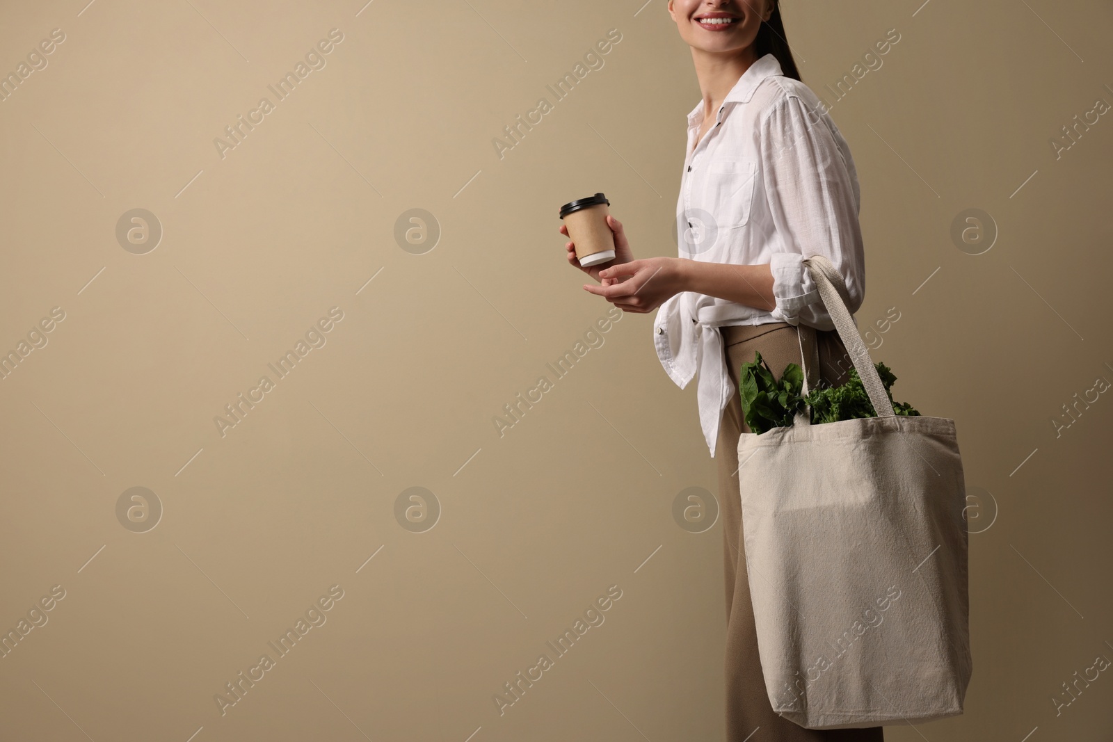 Photo of Woman with eco bag and takeaway cup on beige background, space for text