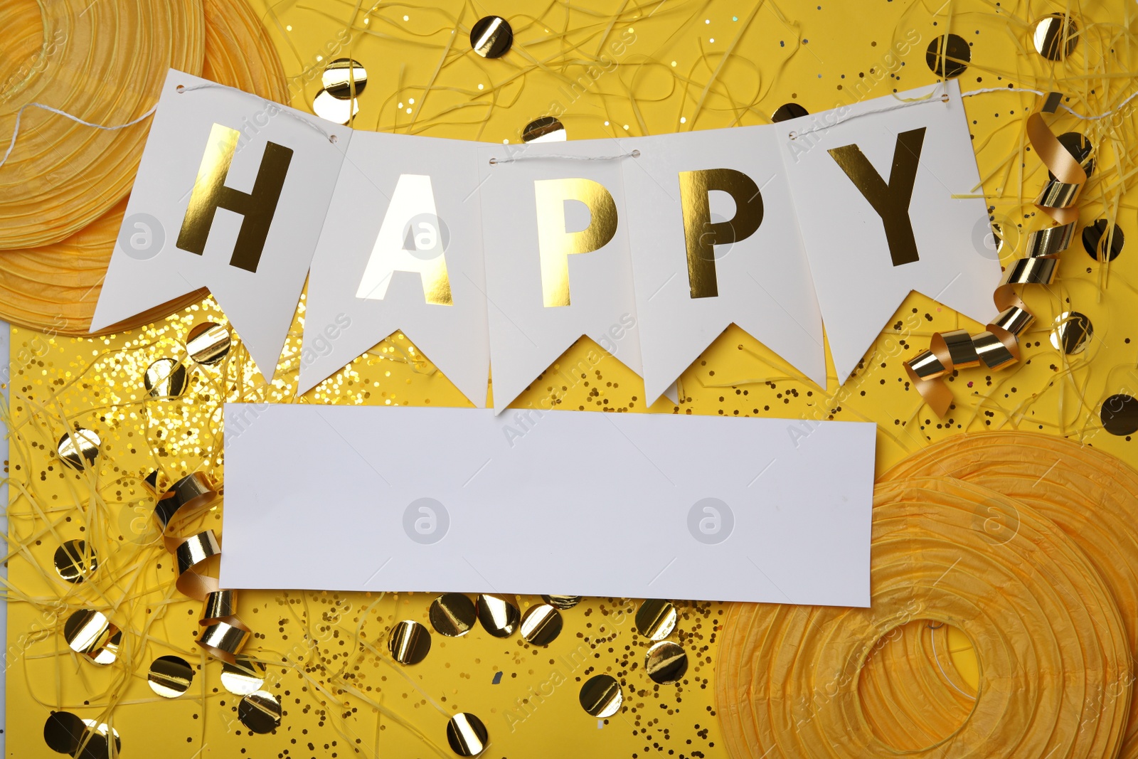 Photo of Flat lay composition with word HAPPY and party decor on yellow background. Space for text