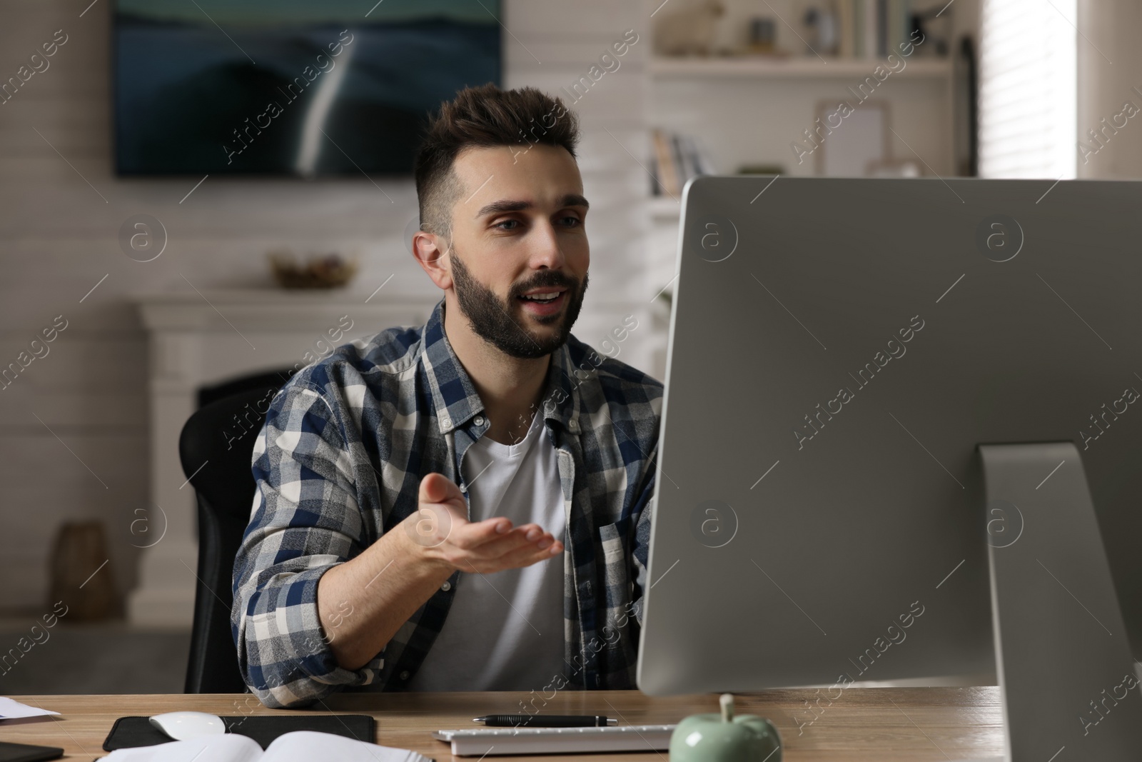 Photo of Man having video call on computer indoors. Working from home