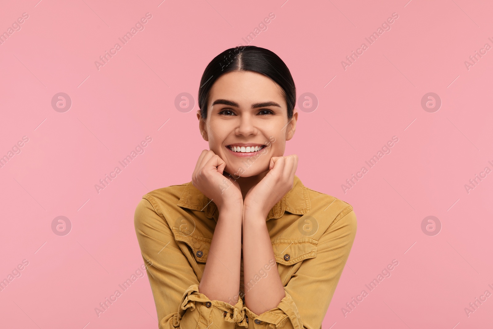 Photo of Young woman with clean teeth smiling on pink background