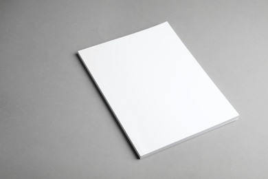 Photo of Brochure with blank cover on grey background. Mock up for design