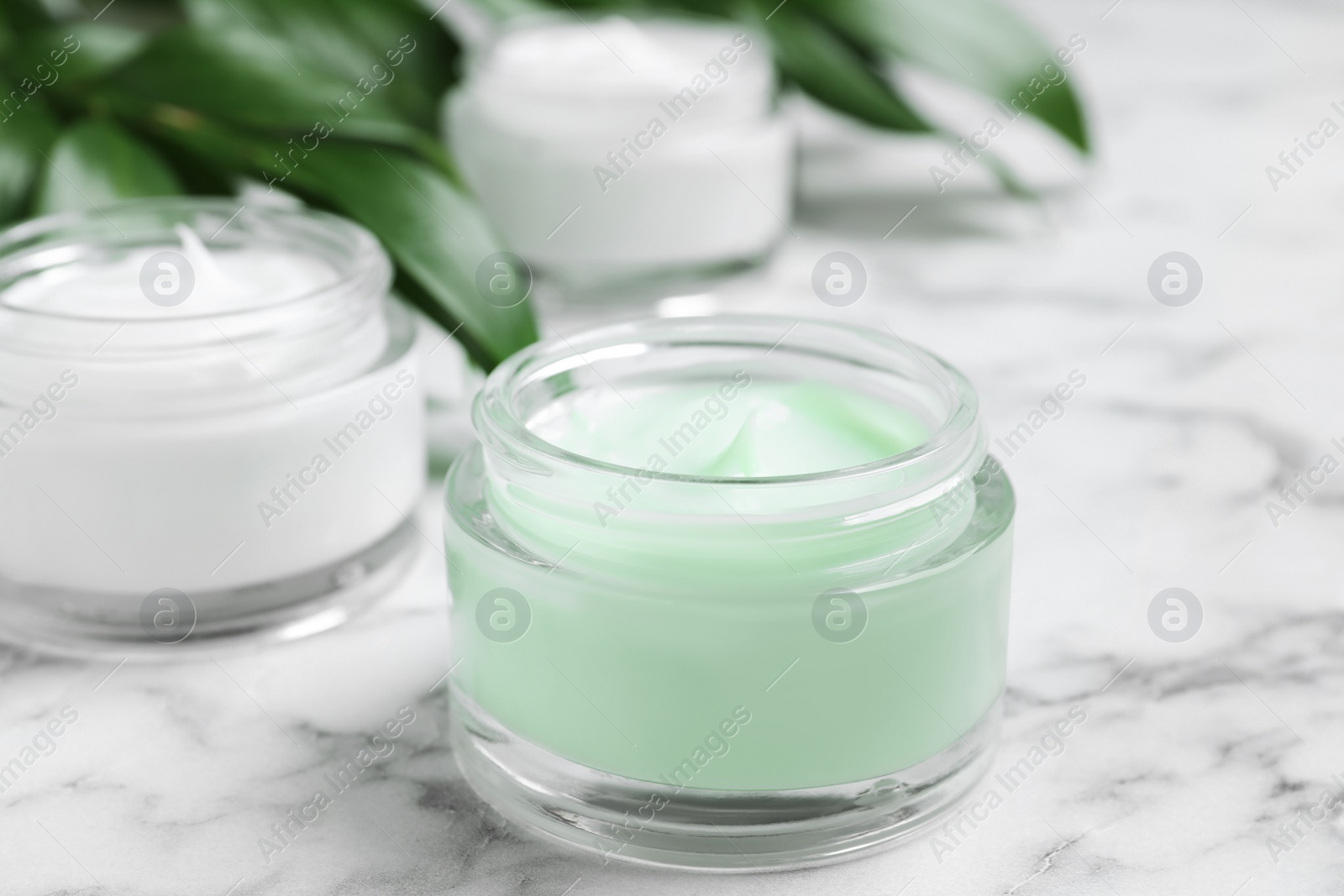 Photo of Jar of organic cream  on white marble table