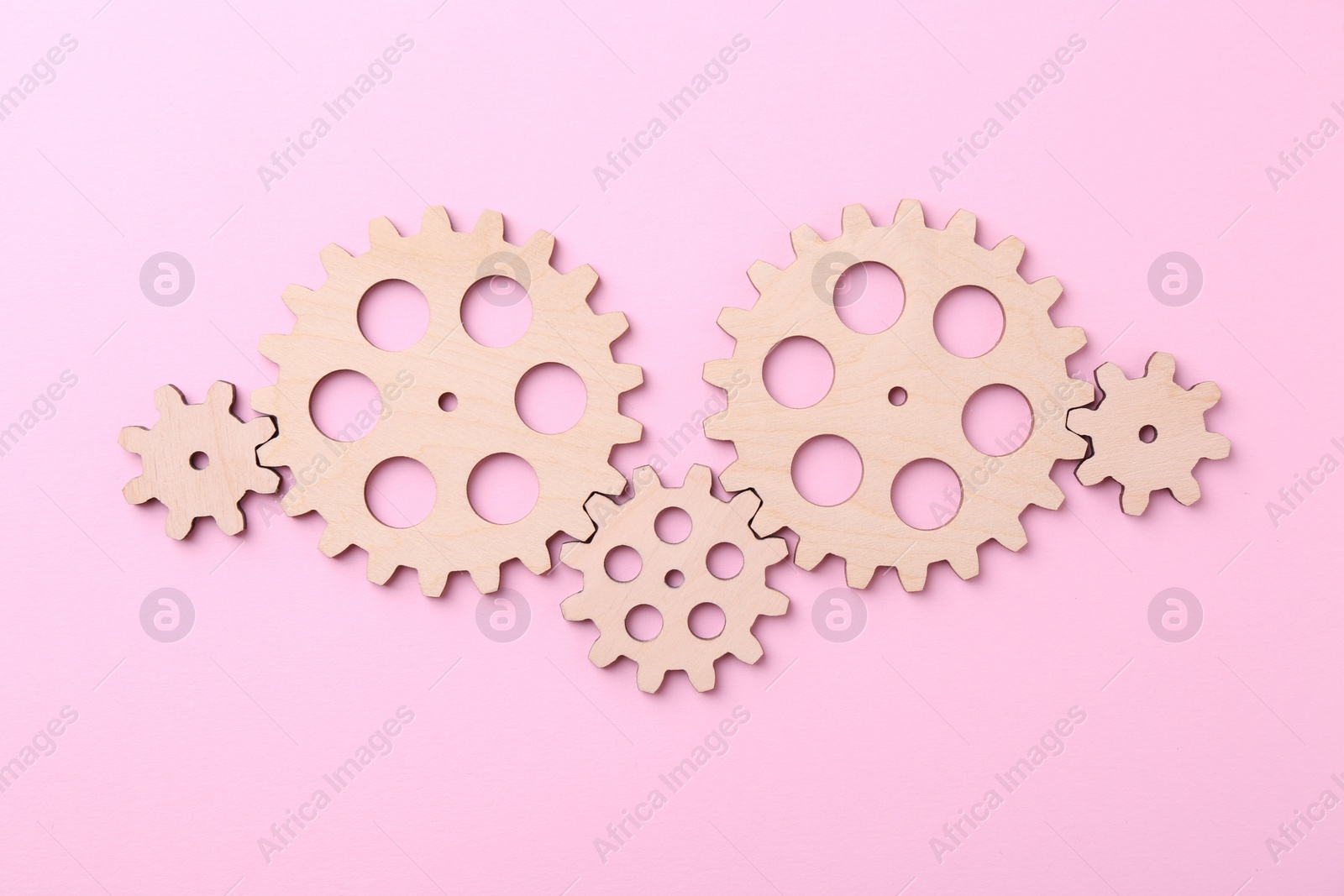 Photo of Business process organization and optimization. Scheme with wooden figures on pink background, top view