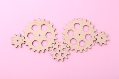 Business process organization and optimization. Scheme with wooden figures on pink background, top view