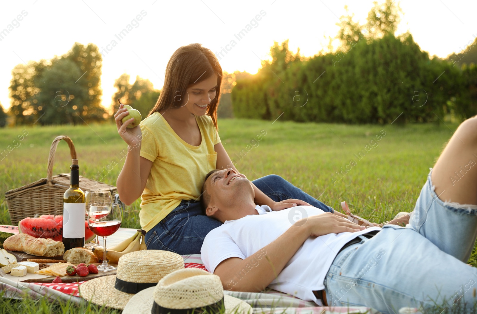 Photo of Happy couple having picnic in park on sunny day