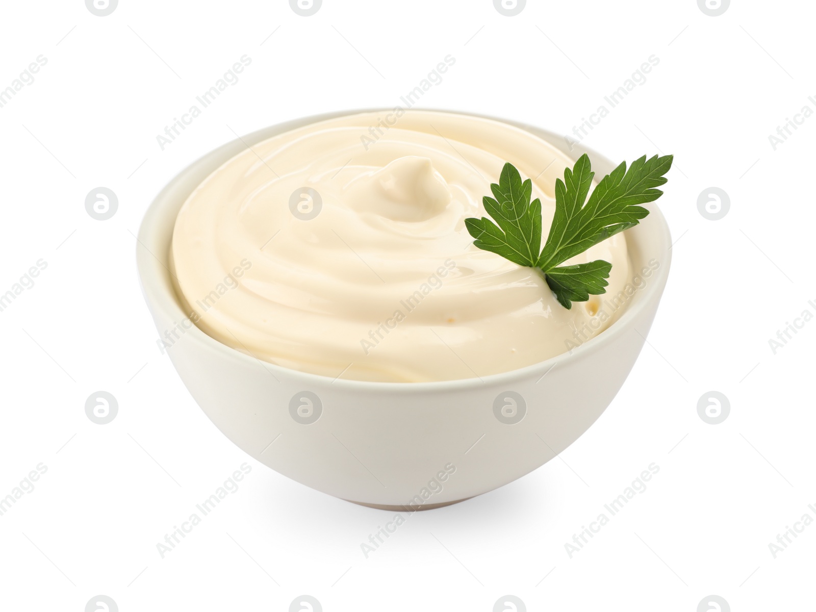 Photo of Bowl of tasty mayonnaise with parsley isolated on white