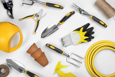 Photo of Flat lay composition with gardening tools on white background