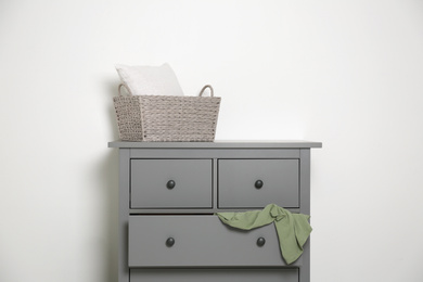 Grey chest of drawers on light background