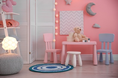 Photo of Modern child room interior with toys and decorations