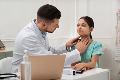 Photo of Pediatrician examining little girl in office at hospital