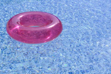 Inflatable ring floating on water in swimming pool, space for text