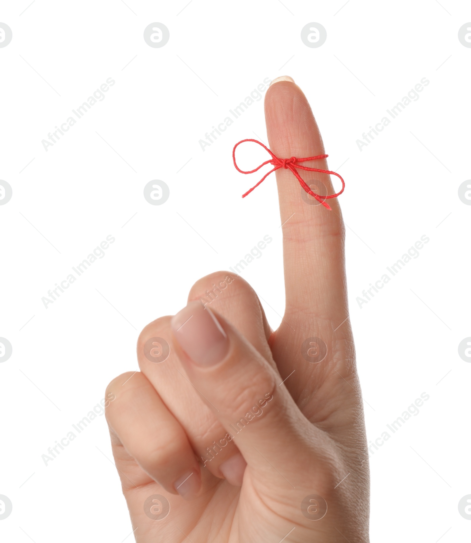 Photo of Woman showing index finger with tied red bow as reminder on white background, closeup