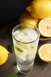 Cool freshly made lemonade and fruits on wooden table