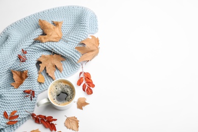 Flat lay composition with coffee and warm plaid on white background, space for text