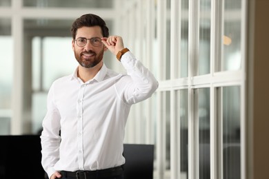 Photo of Portrait of smiling man in office, space for text. Lawyer, businessman, accountant or manager