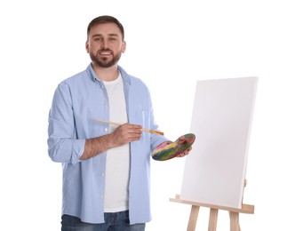 Photo of Man with painting tools near easel on white background. Young artist