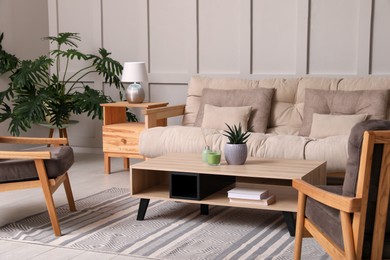 Photo of Stylish living room interior with comfortable sofa, armchairs and beautiful plants