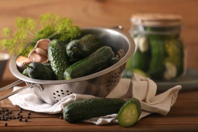 Fresh cucumbers, dill, peppercorns and garlic on wooden table. Pickling recipe